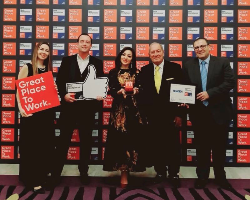 Howden employees holding an award from Best Workplaces in UAE, 2024
